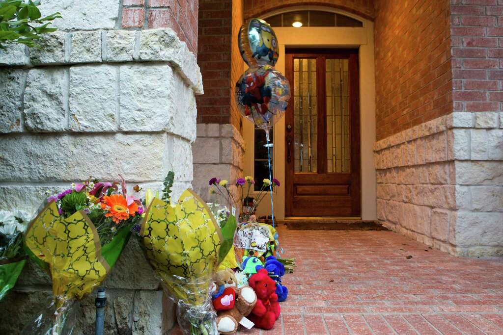 Cards, flowers and balloons have been placed as a memorial on the front porch of the Cypress home where four members of a family were found dead last week. Authorities on Monday said all had been shot in the head. Photo: Marie D. De JesÃ©os, Staff / © 2014 Houston Chronicle