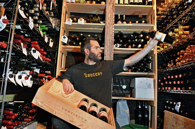 Vic Christopher, co-owner of Lucas Confectionery, cellars bottles of Continuum, a California boutique wine, at his 2nd Street wine bar Friday Feb. 7, 2014, in Troy.    (John Carl D'Annibale / Times Union) Photo: John Carl D'Annibale / 00025678A
