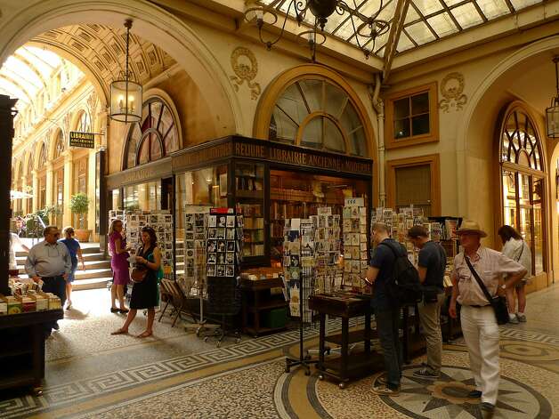Patrons shop for books at Librairie Jousseaume, a bookstore inside Galerie Vivienne that was founded in 1826.Galerie Vivienne Photo: Spud Hilton, The Chronicle