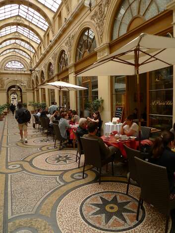 Diners enjoy an afternoon meal at A Priori The, a restaurant in the covered Galerie Vivienne, one of the 20 or so covered passages left from the 19th century. Galerie Vivienne Photo: Spud Hilton, The Chronicle