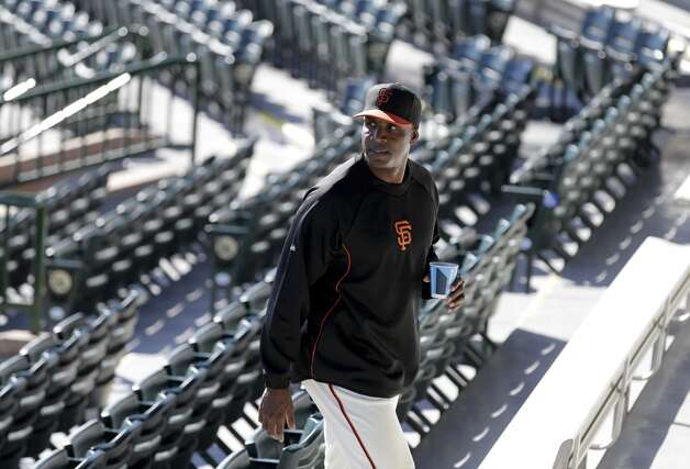 San Francisco Giants manager Bruce Bochy, left, listens as former player Barry Bonds arrives for a news conference before a spring training baseball game in Scottsdale, Ariz., Monday, March 10, 2014. Photo: Chris Carlson, Associated Press