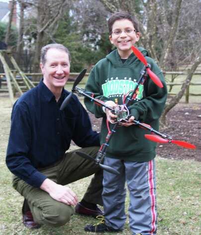 Mark Mathias and son Nick display the quadcopter drone they built. Westport CT. March 2014. Photo: Westport News/Contributed Photo / Westport News