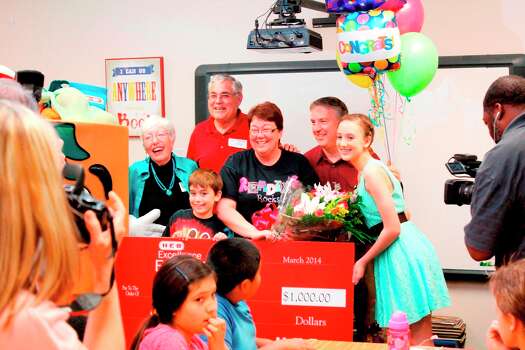 Pamela Berdou, center in glasses, poses with her family after being surprised in her classroom. Photo: Courtesy Lamar Consolidated Independent School District