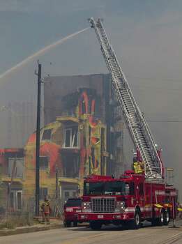 Firefighters battled a five-alarm blaze on March 25 at an apartment complex under construction on West Dallas near Montrose. The five-story, 368-unit building was destroyed. Photo: Johnny Hanson, Staff / © 2014  Houston Chronicle