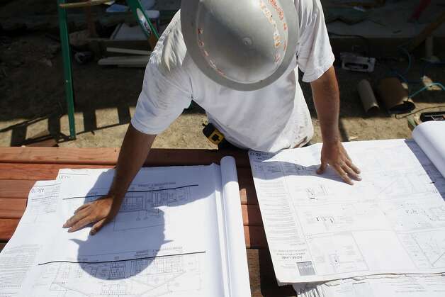 Foreman Efren Castillo looks over blueprints at the building site near Hall Middle School in central Larkspur. Photo: Lacy Atkins, SFC