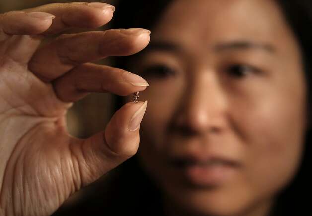 Ada Poon, a Stanford electrical engineer, holds a device that can be implanted in the body and controlled wirelessesly. Photo: Michael Macor, The Chronicle