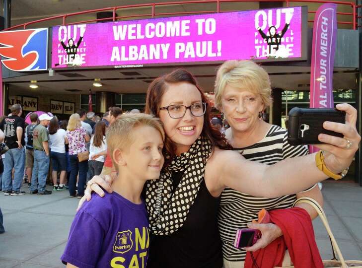 Three generations of Beatles fans, from left, 10-year-old Joshua Moon, his mom Kelly Moon and grandm