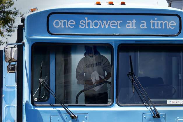A homeless person emerged from his shower on the Lava Mae bus Tuesday June 24, 2014 in San Francisco, Calif. Lava Mae, the program that is turning old MUNI buses into showers for homeless people. began their test run in front of the Mission Neighborhood Resource Center. Photo: Brant Ward, San Francisco Chronicle