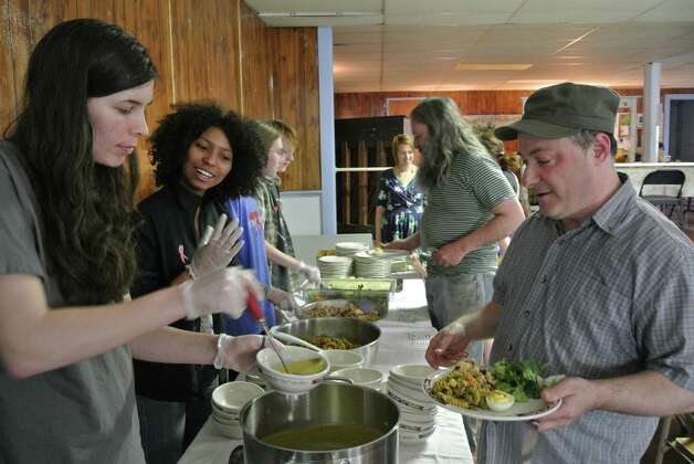 Student volunteers from RPI's Vasudha freshmen living community serve food to patrons of Oakwood Soul Cafe at Oakwood Community Center, April 13, 2015. (Deanna Fox)