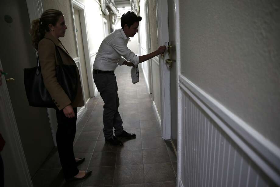 As Megan Filly, Deputy Press Secretary, Superior Court of California, looks on, Krista Gaeta, Deputy Director or Tenderloin Housing Clinic, enters a room at Drake Hotel in San Francisco, Calif., on Monday, May 18, 2015. Photo: Scott Strazzante, The Chronicle