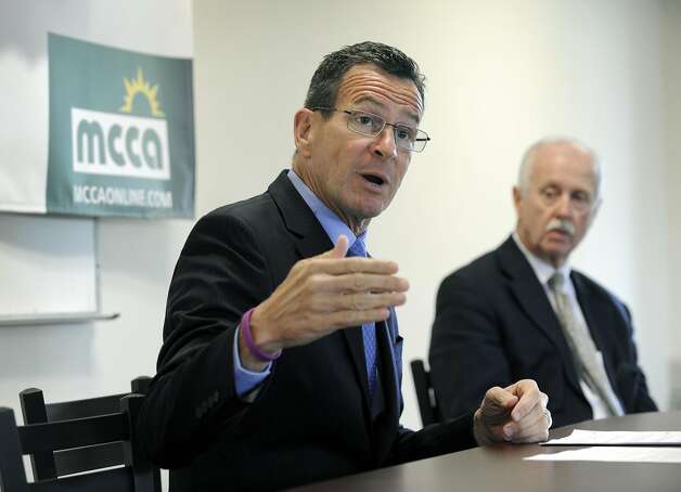 Gov. Dannel P. Malloy holds a news conference at the Midwestern Connecticut Council of Alcoholism (MCCA) in Danbury, Conn., Monday, May 18, 2015. Right is Joseph Sullivan, president and CEO of MCCA. Photo: Carol Kaliff