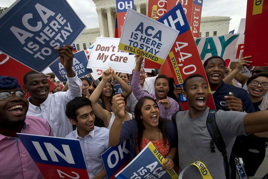Students cheer as they hold up signs supporting the Affordable Care Act (ACA) after the Supreme Court decided that the ACA may provide nationwide tax subsidies, Thursday June 25, 2015, outside of the Supreme Court in Washington. (AP Photo/Jacquelyn Martin) Photo: Jacquelyn Martin, Associated Press