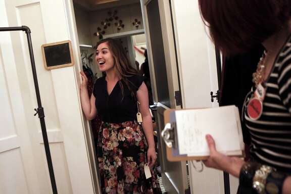 Allison Judge of New Jersey tries on clothes with the help of stylist Christine Shoptaw de Chavez of Los Angeles during the soft opening of ModCloth Fit Shop in San Francisco on Monday, July 27, 2015.