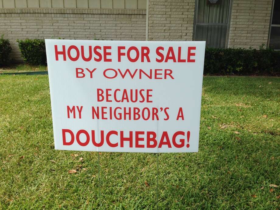 A Farmers Branch couple put this sign in their front yard after tensions with their nextdoor neighbors heated up over barking dogs, Aug. 14, 2015. (Courtesy of James Price)PHOTOS: See 13 more homes and real estate additions done completely out of spite for the neighbors ...