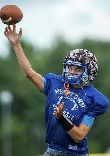 Newtown High School quarterback Justin Dunn thowing a pass during ...