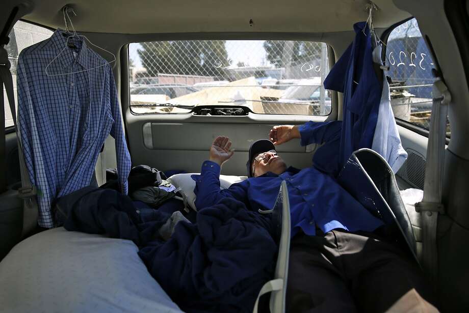 Apple bus driver Scott Peebles naps between shifts. He lives in his van because he can’t afford a place to live. Photo: Scott Strazzante, The Chronicle