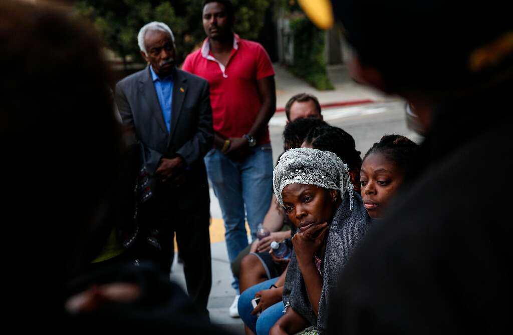Nadege Nadege listens at a candlelight vigil for Yonas Alehegne, an Ethiopian immigrant who was shot and killed by an Oakland police officer in August, in Oakland, Calif., on Sunday, September 13, 2015. Photo: Sarah Rice, Special To The Chronicle