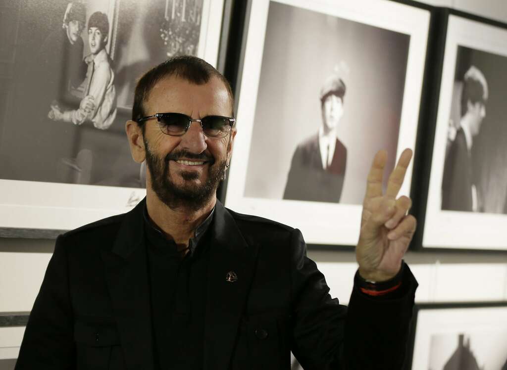 Pop icon and former Beatle Ringo Starr poses for the media in front of some of his photographs during a photocall as he launches a book called 'Photograph' in London, Wednesday, Sept. 9, 2015. The book contains photographs by Starr from his childhood, the Beatles and beyond. (AP Photo/Alastair Grant) Photo: Alastair Grant, Associated Press