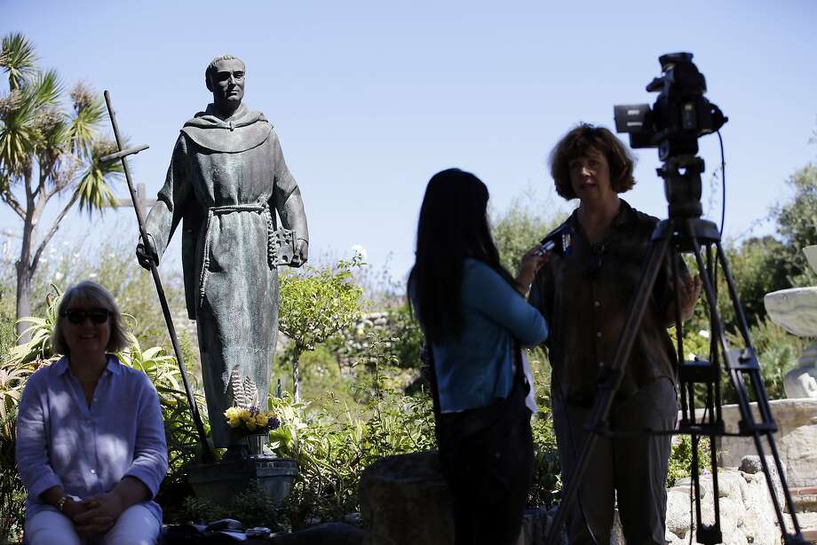 An interview is conducted next to a statue of Junipero Serra at the Carmel Mission, Wednesday, Sept. 23, 2015, in Carmel-By-The-Sea, Calif. Serra, an 18th-century missionary who brought Catholicism to the American West Coast, was elevated to sainthood Wednesday by Pope Francis in the first canonization on U.S. soil. (AP Photo/Marcio Jose Sanchez) Photo: Marcio Jose Sanchez, Associated Press