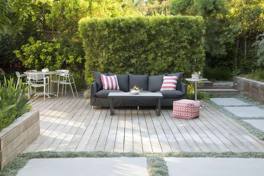 Alice and Dennis Oliver of San Mateo replaced their backyard lawn with a large deck and spaces for easy entertaining. Photo: Caitlin Atkinson