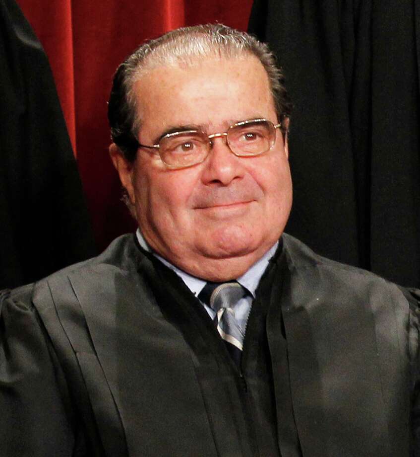 Justice Antonin Scalia poses for a group portrait of the Supreme Court in this file photo. Photo: Pablo Martinez Monsivais, STF / 2010 AP