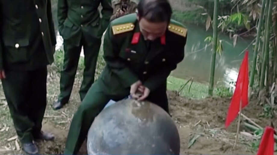 Vietnam's military is investigating three large metal balls, believed to be space junk, which landed in the country's remote north last weekend. Photo: VTV3