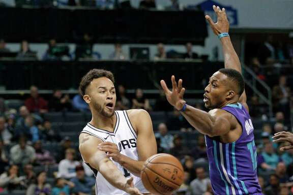 San Antonio Spurs' Tim Duncan (21) shoots over Charlotte Hornets' Cody Zeller (40) during the first half of an NBA basketball game in Charlotte, N.C., Monday, March 21, 2016.