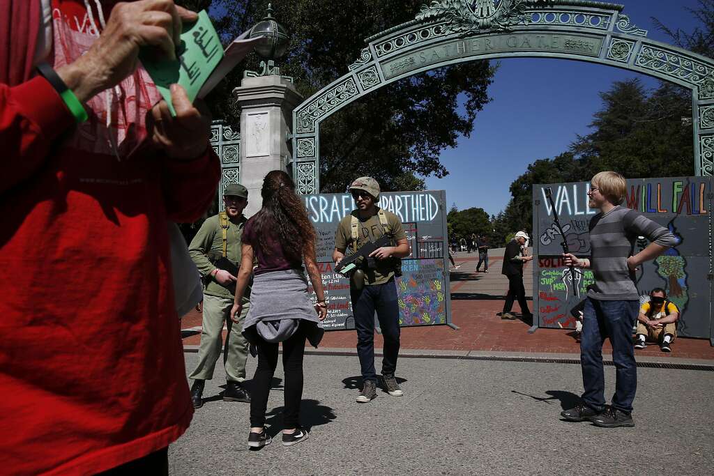 David McCleary (right) takes video as Palestinians’ supporters role-play during a mock Israeli checkpoint demonstration near Sather Gate at UC Berkeley. Photo: Leah Millis, The Chronicle