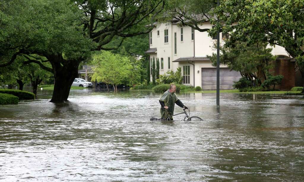 Barnie Burton walks along a flooded Chimney Rock Road, as he looks for food for his cats, after Brays Bayou flooded the Meyerland area, Monday, April 18, 2016, in Houston. Photo: Jon Shapley, John Shapley/Houston Chronicle / © 2015  Houston Chronicle