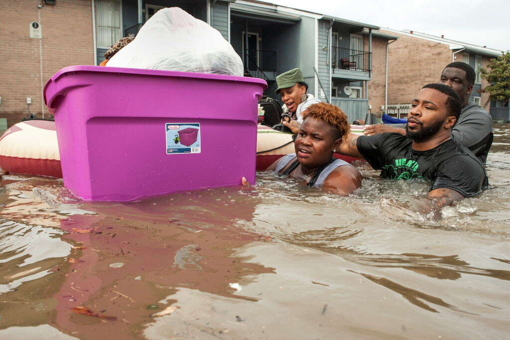 Residents of the Arbor Court apartments evacuate their flooded apartment complex in the Greenspoint area on Monday, April 18, 2016, in Houston, Texas. Photo: Brett Coomer, Associated Press / Houston Chronicle