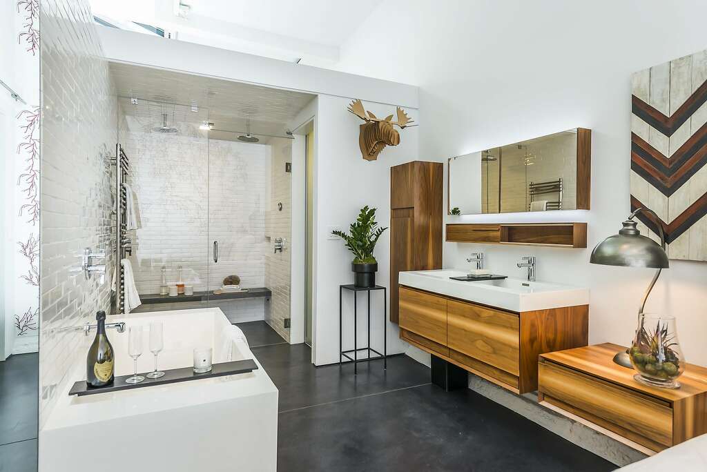 The master suite includes a soaking tub and floating vanity, as well as a rain shower with steam shower capabilities. Photo: Olga Soboleva / Vanguard Properties