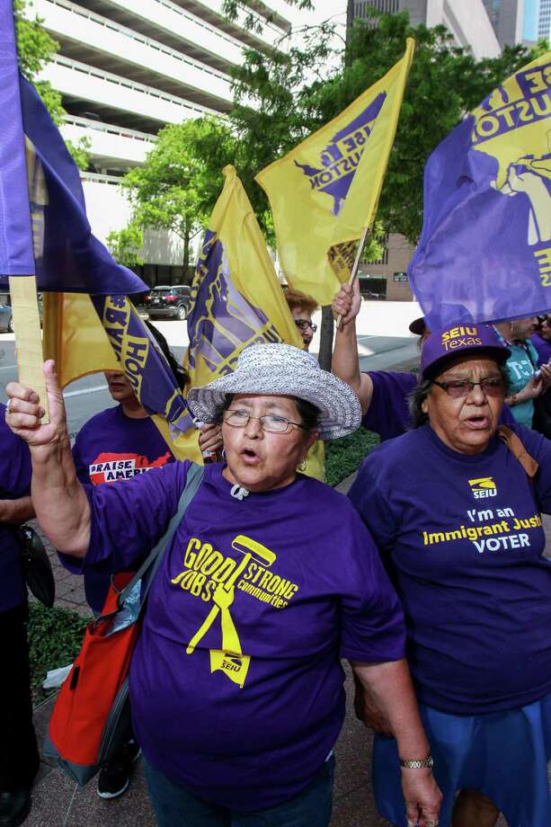 Francisca Reyes, left, and Austroberta Rodriguez march in a rally for janitors in June. Photo: Gary Fountain, For The Chronicle / Copyright 2016 Gary Fountain