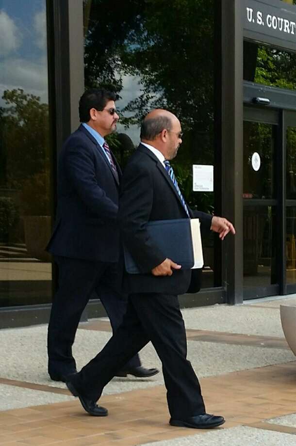 Samuel Mullen, (left) who is alleged to have bribed an insurance consultant for area school districts, walking out of federal court today in San Antonio with his lawyer, David R. Gorena (right). Mullen entered a not guilty plea to a charge of conspiracy to commit wire fraud. Photo: /Guillermo Contreas /Staff / San Antonio Express-News