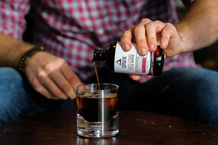 Somatik CEO Chris Schroeder pours his cold brewed coffee infused with THC into a glass at his office in Oakland, Calif., on Tuesday, Jan. 17, 2017. Somatik is partnering with Ritual coffee to release an 8-oz bottle of cold brewed coffee with 15 mg of THC in it which is slated to hit the market next week. Photo: Gabrielle Lurie, The Chronicle