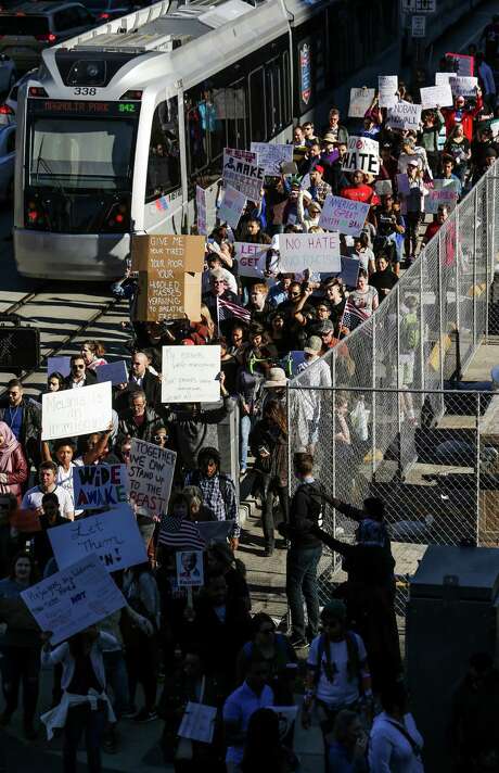 Hundreds of people protesting President Donald Trump's executive order on immigration march down Rusk Street outside Super Bowl Live in downtown Houston Sunday. ( Michael Ciaglo / Houston Chronicle ) Photo: Michael Ciaglo, Staff / Â© 2016  Houston Chronicle
