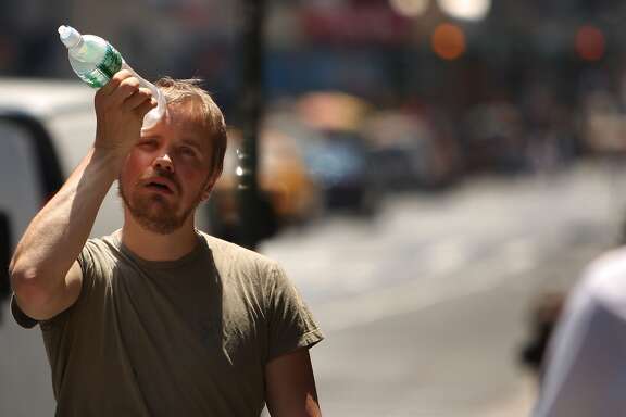 New York City Hit With Stifling Record Heat NEW YORK - JUNE 9: A man tries to cool himself with a bottle of water during the first heat wave of the year June 9, 2008 in New York City. According to the National Weather Service temperatures will near 100 degrees today in the New York metro area with no relief in sight until Wednesday, June 11. (Photo by Spencer Platt/Getty Images)