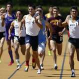 Campolindo's Niki Moore (center) edges out De La Salle High's Isaias De Leon (right) and the rest of the field to take first place in the boys 800 meter run at the North Coast Section Meet of Champions in Berkeley, Calif. on Saturday, May 27, 2017.
