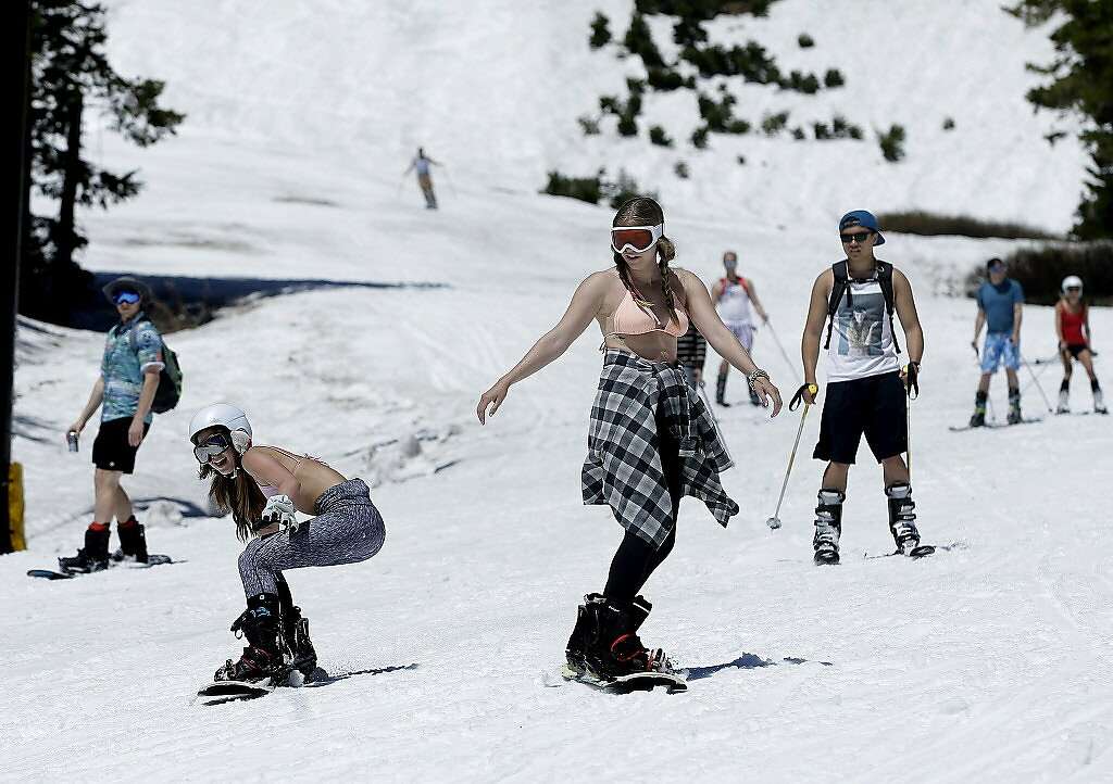 Snow boarders and skiers didn't bundle up as temperatures hovered in the high 60's to low 70's at the Squaw Valley Ski Resort, Saturday, July 1, 2017, in Squaw Valley, Calif. Because of this years heavy snow fall Squaw Valley is expected to be open through the 4th of July, only the fourth time the resort has been open for skiing in July. (AP Photo/Rich Pedroncelli) Photo: Rich Pedroncelli, Associated Press