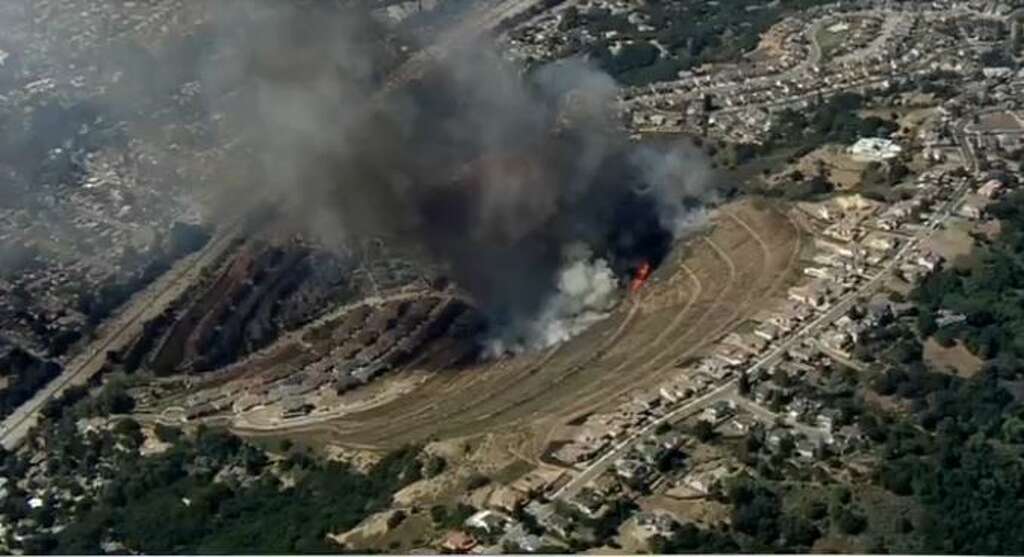 A fire burned near homes Tuesday afternoon in Oakland.  Photo: KTVU