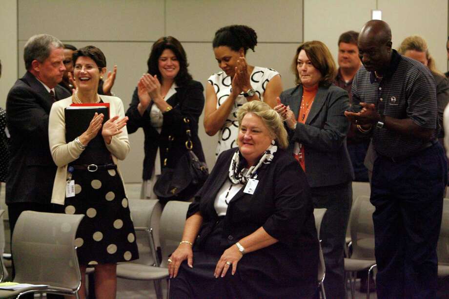 Surrounded by supporters Melinda Garrett, (center) is applauded as she was announced as the HISD interim CFO at the Hattie Mae White Educational Support Center during an HISD board meeting Thursday, Aug. 20, 2009, in Houston. 
( Johnny Hanson / Chronicle ) Photo: Johnny Hanson, Staff / Houston Chronicle