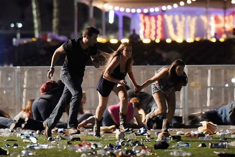 People run from the Route 91 Harvest country music festival after gun fire was heard on October 1st, 2017, in Las Vegas, Nevada. A gunman opened fire on a music festival in Las Vegas, leaving at least 59 people dead and more than 500 injured.  Photograph: David Becker/Getty Images.