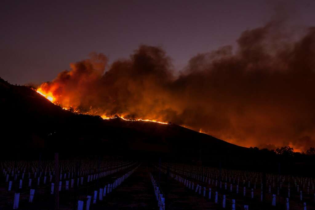 Flames moved through the hills above the Silverado Trail as a fast moving wind whipped wild fire raged though the Napa County on Monday, October 9, 2017. Photo: Peter DaSilva, Special To The Chronicle