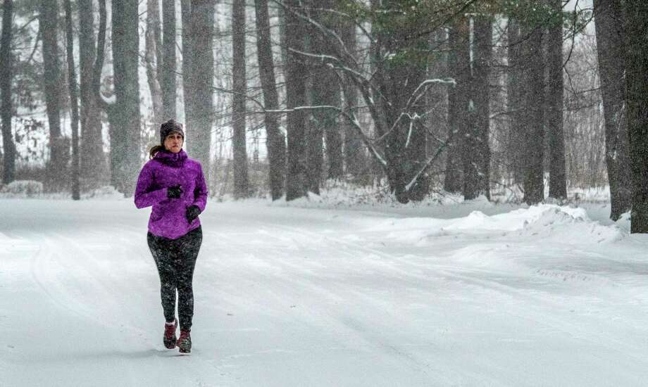 Carrie Robinson of Ballston Spa is out for a jog in the fresh snow at the Saratoga State Park Friday Dec 22, 2017 in Saratoga Springs, N.Y.  (Skip Dickstein/ Times Union) Photo: SKIP DICKSTEIN, Albany Times Union