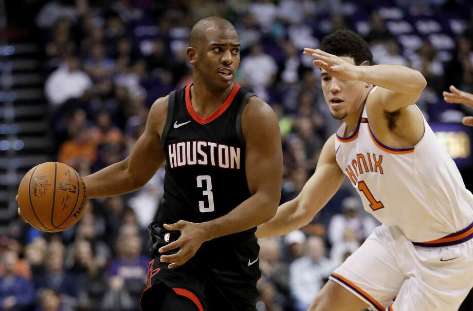 Houston Rockets guard Chris Paul (3) drives against Phoenix Suns guard Devin Booker (1) during the first half of an NBA basketball game, Friday, Jan. 12, 2018, in Phoenix. (AP Photo/Matt York) Photo: Matt York/Associated Press