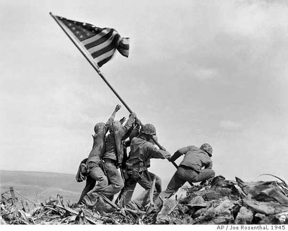 ** FILE ** In a file photo U.S. Marines of the 28th Regiment of the Fifth Division raise the American flag atop Mt. Suribachi, Iwo Jima, on Feb. 23, 1945. Joe Rosenthal, who won a Pulitzer Prize for his immortal image of six World War II servicemen raising an American flag over battle-scarred Iwo Jima, died Sunday. He was 94. (AP Photo/Joe Rosenthal) Photo: JOE ROSENTHAL