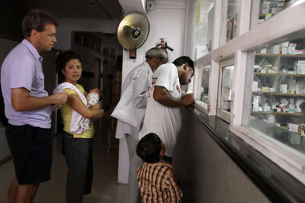 Steve Kowalski and Jennifer Benito-Kowalski take baby Kyle to pick up medication for his upcoming flights to Mumbai and the U.S. at the pharmacy in the Apara Nursing Home in Anand, India, Friday, May 31, 2013. Photo: Nicole Fruge, The Chronicle