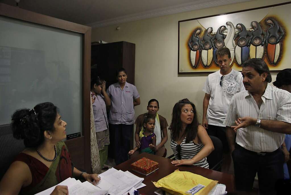 Jennifer Benito-Kowalski (third from right) and Steve Kowalski (second from right) are greeted by Dr. Nayna Patel (left) and her husband, Dr. Hitesh Patel (right) when they arrive at Akanksha Infertility Clinic in Anand, India, Wednesday, May 22, 2013. After years of trying to conceive a child, the Kowalskis paid a surrogate in India to carry their child. Surrogate Manisha Parmar is in the background with daughter Urvashi, 3. It was the first face-to-face meeting between the surrogate and the Kowalskis. Photo: Nicole Fruge, The Chronicle