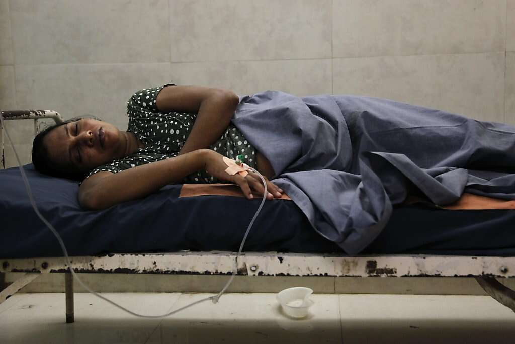 Surrogate Manisha Parmar tries to rest after receiving an intravenous line at the Akanksha Infertility Clinic in Anand, India, Thursday, May 23, 2013. Dr. Nayna Patel said she was in spontaneous labor, but Parmar delivered by cesarean section later that day. Photo: Nicole Fruge, The Chronicle