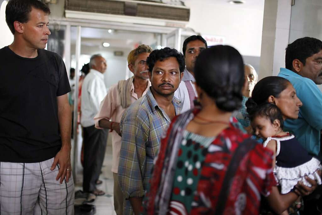 Steve Kowalski (left) waits for an appointment with a pediatrician at the Apara Nursing Home in Anand, India, Friday, May 24, 2013. Photo: Nicole Fruge, The Chronicle