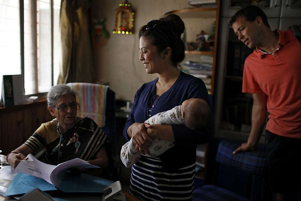Pediatrician Dr. Anita Kothiala meets with Jennifer Benito-Kowalski and Steve Kowalski during a vaccination appointment for baby Kyle at the Apara Nursing Home, Monday, May 27, 2013, in Anand, India. Photo: Nicole Fruge, The Chronicle